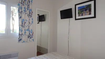 Very beautiful T2 on the ground floor with trees, swimming pool, sea view, shops and beach Hotels near Mas des Romarins