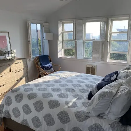Bright airy Fair Harbor home with ocean views steps from the soft sandy beach