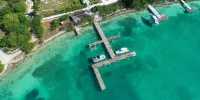 Stunning waterfront property with panoramic sunset views + pool + dock