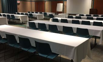 a large conference room with multiple rows of tables and chairs arranged for a meeting at General Butler State Resort Park