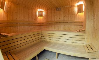 a wooden sauna with benches and lanterns , giving it a cozy and inviting atmosphere at Green Life Family Apartments Pamporovo