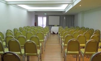 a large conference room with rows of chairs arranged in a semicircle , ready for a meeting or presentation at Hotel Monaco
