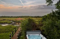 Marsh front villa on an acre. Private Dock + hot tub, steps from the beach