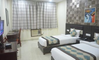 a hotel room with two beds , one on the left and one on the right side of the room at Leisure Resort