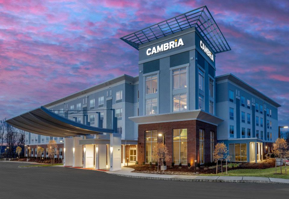 "a large building with a sign that reads "" cambria "" prominently displayed on the front" at Cambria Hotel West Orange