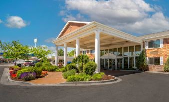 a large , white hotel building with columns and a green lawn in front of it at Best Western Plus Burley Inn  Convention Center