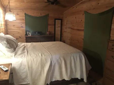 Private lakefront getaway with a sandy beach below the back deck!