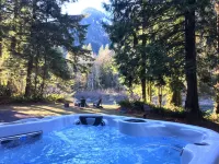 Luxury Riverfront Log Cabin Near Stevens Pass with Hot Tub & Two-Story Fireplace