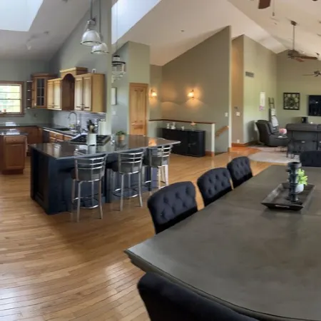 Fully custom modern four bedroom home on 13 acres with a stocked pond.