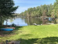 Clean cottage on the Eagle River Chain, dock, firewood, edge of town