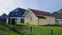 Close to the beach holiday home in a quiet field location with a spacious wooden terrace