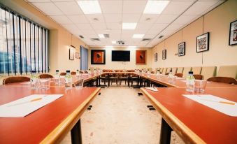 a large conference room with multiple rows of tables and chairs arranged for a meeting at Napoleon