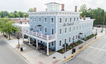 a blue building with white trim and balconies is the carlyle hotel in charlottesville , virginia at The Cadillac House