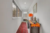 Luxurious midcentury modern glass house in the woods, chefs kitchen & great art