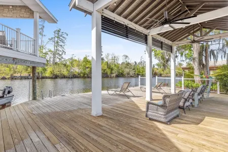 Luxury riverfront home w/ pool, fishing dock, & boat house w/ lift ! Sleeps 14