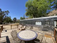 Vintage wood paneled travel trailer on Kernville Ranch with horses and hot tub