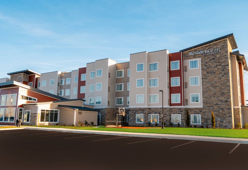 a large hotel building with multiple entrances and a parking lot in front of it at Residence Inn Upper Marlboro Joint Base Andrews