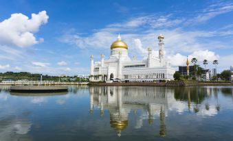 a large white and gold building , possibly a mosque , surrounded by water and a body of water at Terrace Hotel