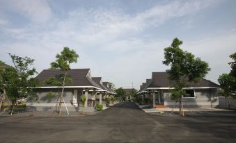 a residential area with several houses , some of which have trees and shrubs , surrounded by a street at Rongsang Resort