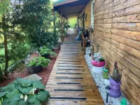 Log Cabin house on 10.5 acers of wooded land. Accommodates 20 plus guest.