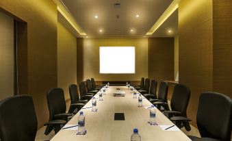 a conference room with a long table , chairs , and water bottles set up for a meeting at Hyatt Place Hampi