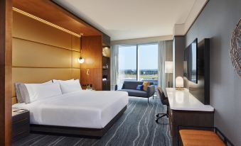 a large hotel room with a king - sized bed , a desk , a chair , and a tv . the room is well - appointed and at InterContinental Hotels Minneapolis - ST. Paul Airport