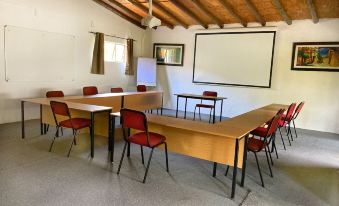a large room with multiple tables and chairs arranged for a meeting or training session at Pine Valley Lodge