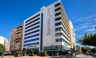 "a large white building with the word "" barceló "" on it is shown from a low angle" at Occidental Cádiz