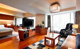 The living room is modern and features large windows, a flat-screen TV, and other furniture at the Westin Guangzhou