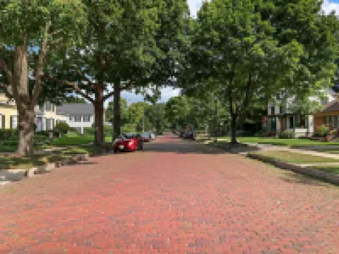 Historic house on tree lined red brick street of historic homes. Hotels in Racine