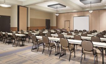 a large conference room with rows of chairs arranged in a semicircle around a table at King's Pointe Waterpark Resort