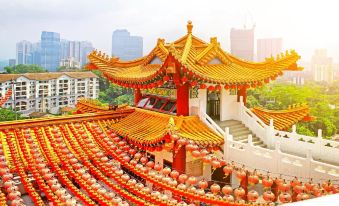 A city with numerous red and yellow buildings in the background, one of which has been at Hotel Transit Kuala Lumpur