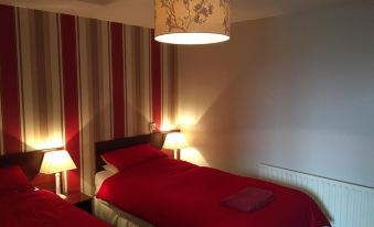 a hotel room with two beds , one on the left and one on the right side of the room at The White Horse