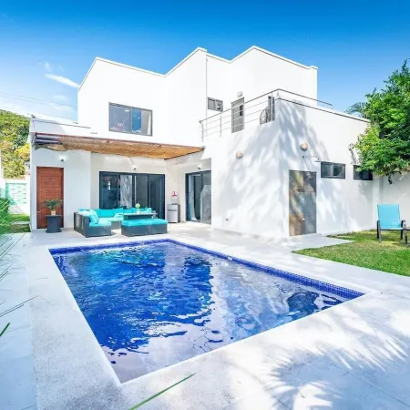 Ultramodern Townhome with an Inviting Coastal Design and Lush Outdoor Oasis with a Private Pool