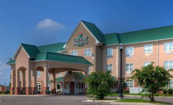 "a large building with a green roof and the words "" country inn & suites "" on it" at Country Inn & Suites by Radisson, Emporia, VA