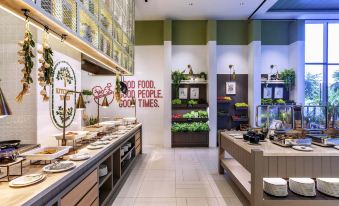 a modern dining room with a variety of dishes and utensils , including bowls , forks , knives , and spoons at Mercure Tangerang BSD City