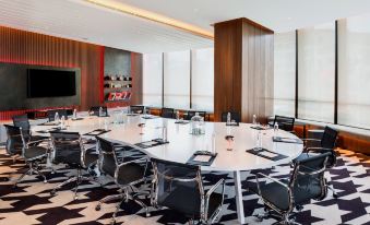 There is a spacious conference room equipped with long tables and chairs suitable for meetings and other business events at W Shanghai - The Bund