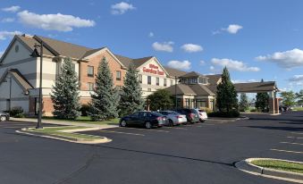 "a large building with a sign that reads "" fairfield inn & suites "" prominently displayed on the front of the building" at Hilton Garden Inn Oconomowoc