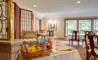 a dining room with a table set for a meal , featuring a variety of food items and utensils at The Clarkson Inn