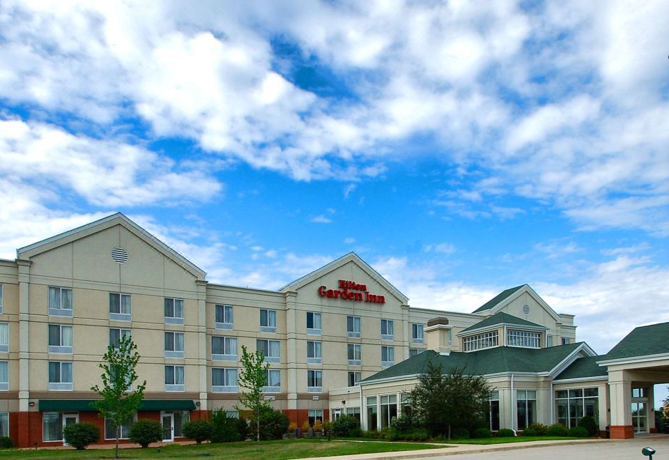 "a large hotel building with a red sign that reads "" hilton garden inn "" prominently displayed on the front of the building" at Hilton Garden Inn Kankakee