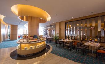 a modern dining area with a gold bar and several chairs surrounding it , creating an elegant atmosphere at Hotel Ciputra Cibubur Managed by Swiss-Belhotel International