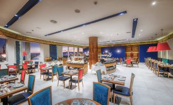 a large , well - lit restaurant with multiple dining tables and chairs arranged in an orderly fashion at Marina Bay City Center