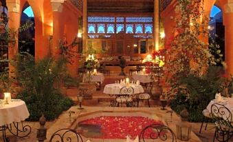 a beautifully decorated dining room with tables and chairs arranged for a group of people to enjoy a meal together at Al Moudira Hotel