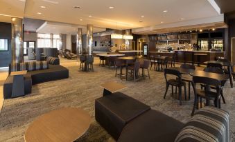 a modern hotel lobby with a bar , lounge area , and comfortable seating arrangements for guests at Courtyard Bay City