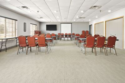 a large conference room with chairs arranged in rows and a whiteboard on the wall at Country Inn & Suites by Radisson, Watertown, SD