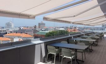 an outdoor dining area with several tables and chairs , providing a pleasant atmosphere for patrons to enjoy their meals at Hotel Imperial