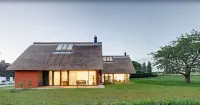 Thatched roof meets modernity, lake view; sauna, garden and much more...