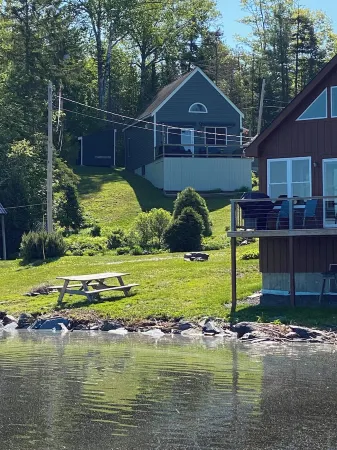 Beautiful lakefront camp with sunset view over big moose mountain