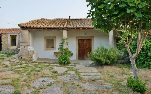 Stone house with garden, barbecue and fireplace.