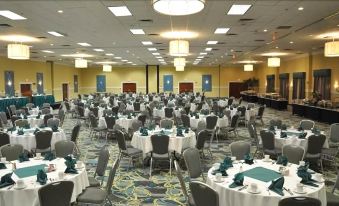 a large banquet hall with numerous tables and chairs , all set up for a formal event at DoubleTree by Hilton Richmond - Midlothian